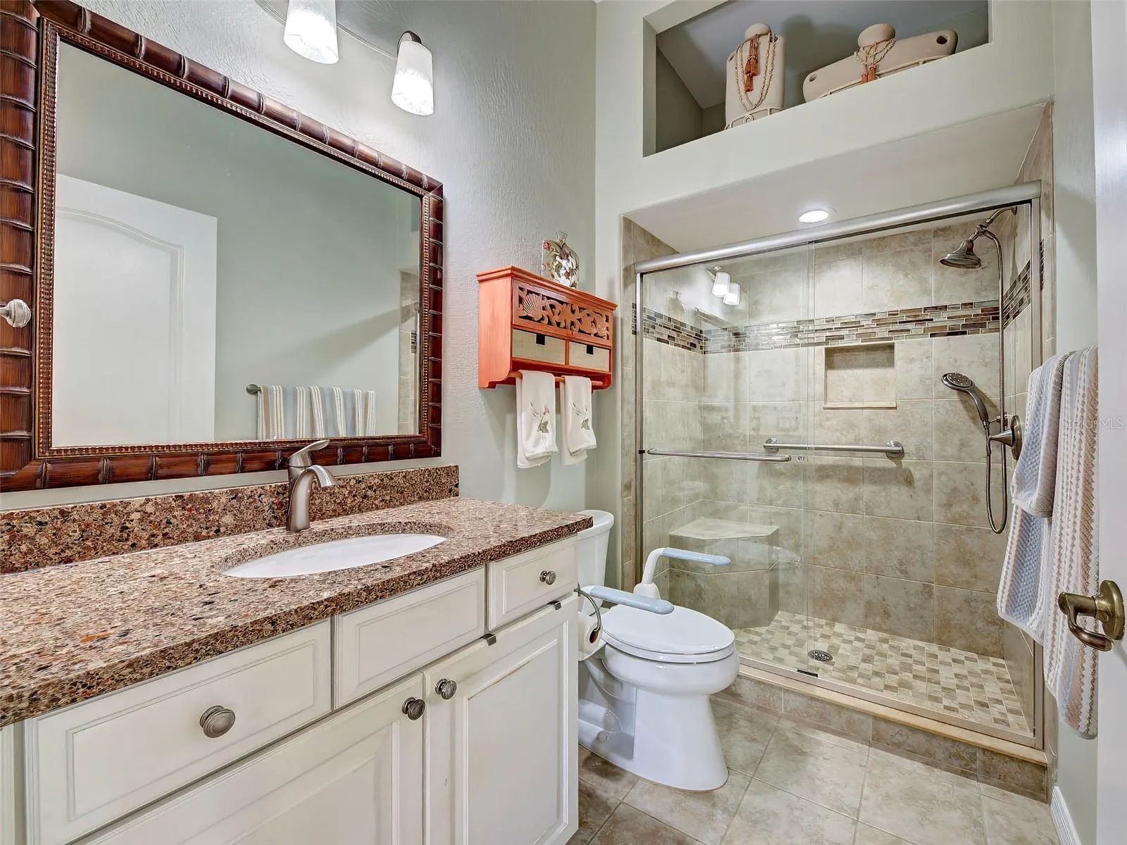 The primary bathroom has a beautifully tiled shower.