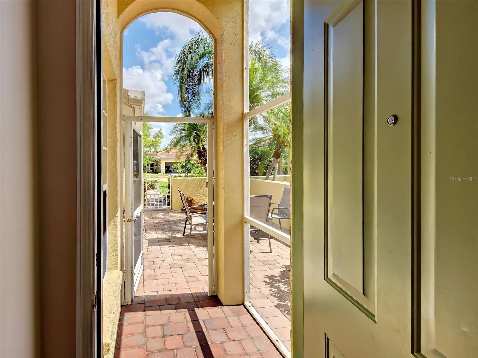 The screened front porch entrance and door into the home.
