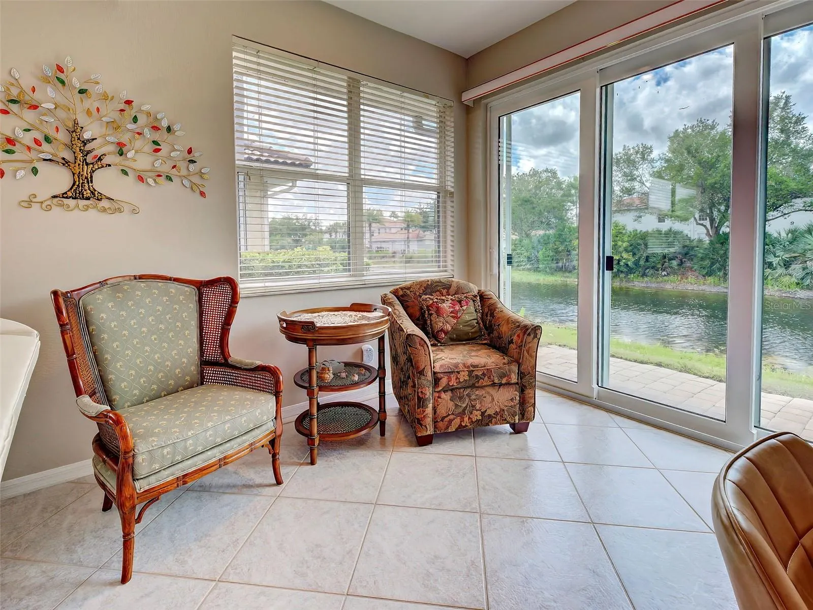 Sliding doors open to a brick patio and the pond.  Peaceful place to enjoy the outdoors and still be comfortable from the Florida heat.