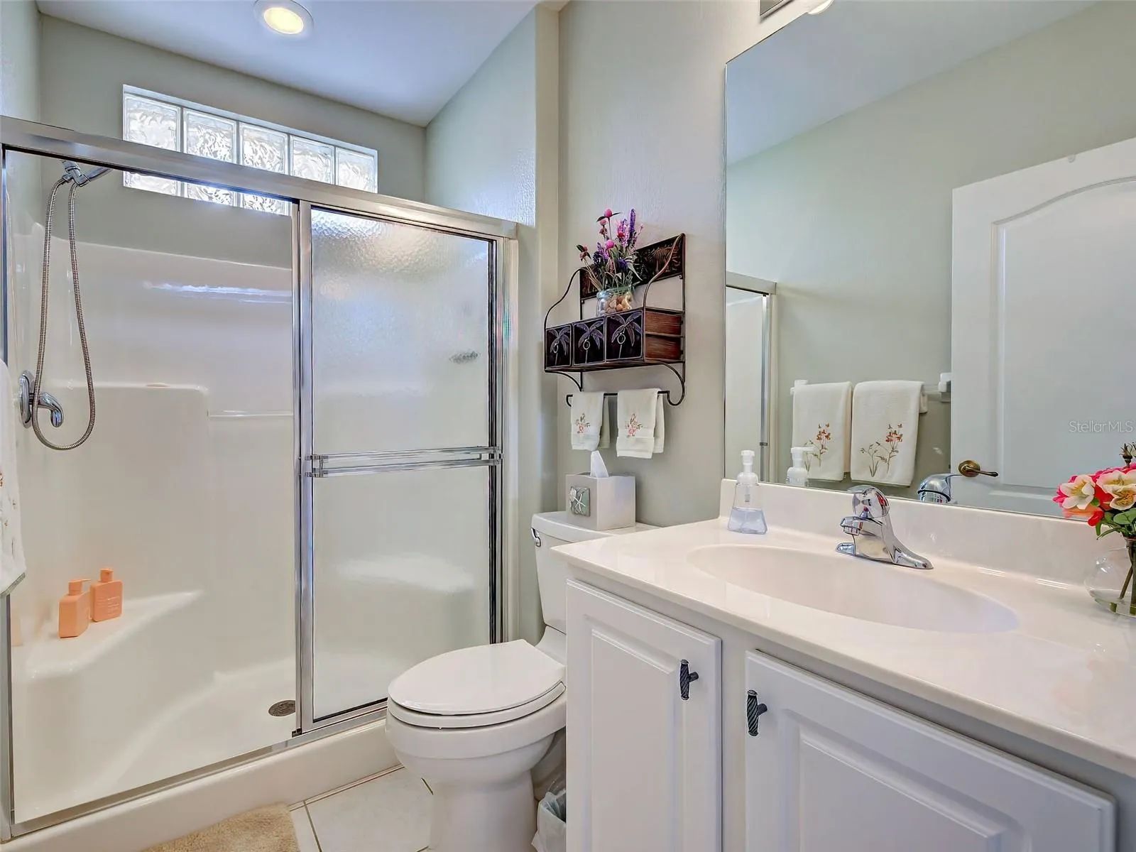 The guest bathroom has built in seating in the shower and glass block to let the light in.