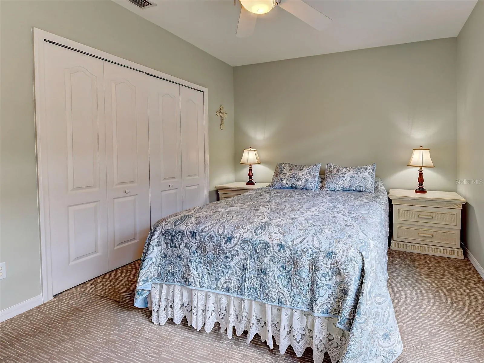 The guest bedroom is carpeted and has double built in closets.