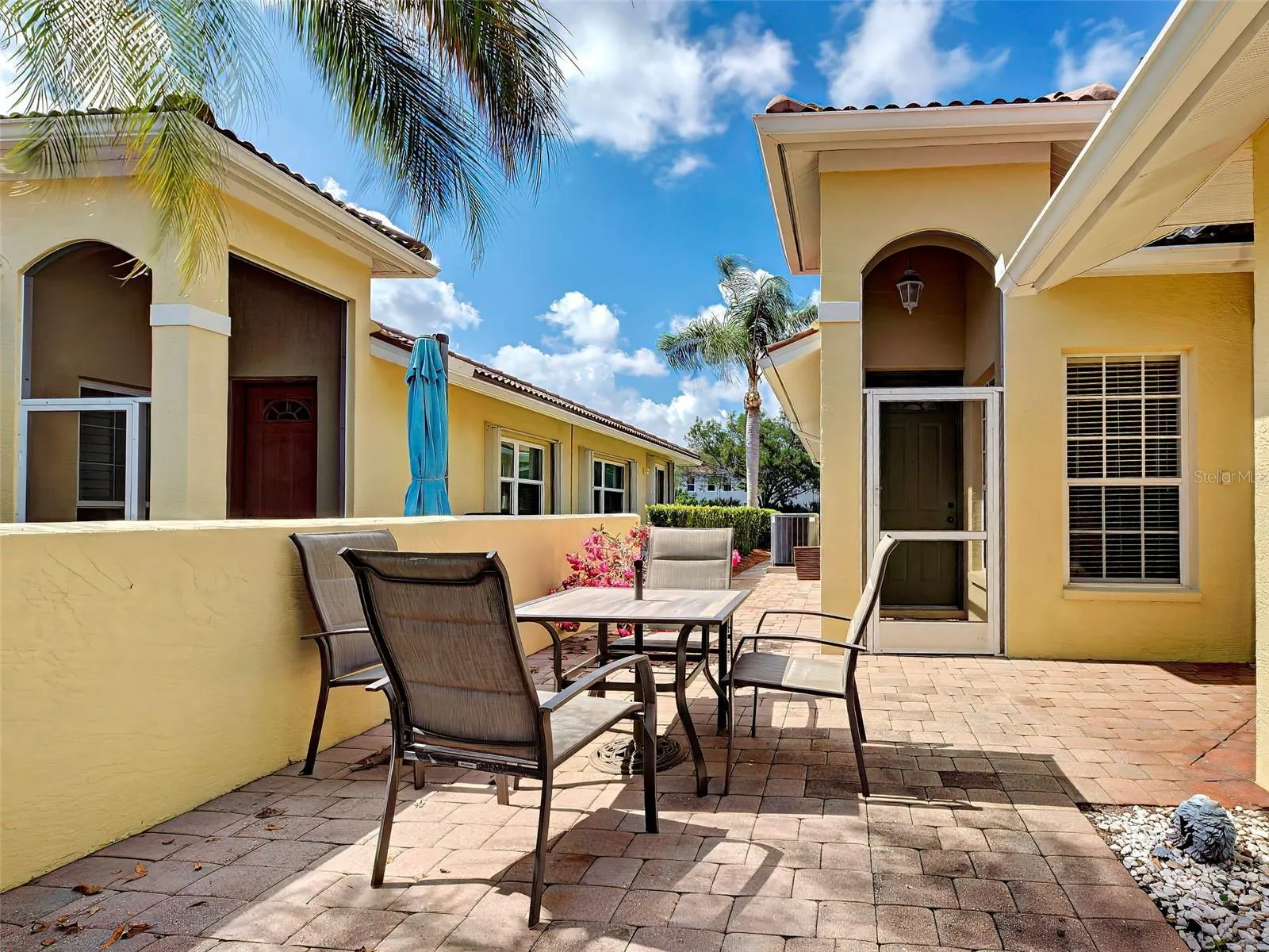 The front porch is screened and there is plenty of room on the pavered patio for a dining table.