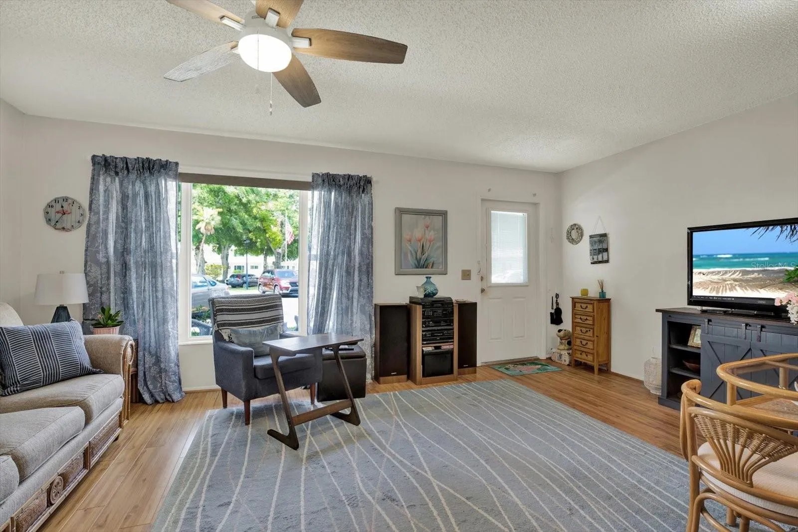 Living room with large window and wood-look vinyl floors