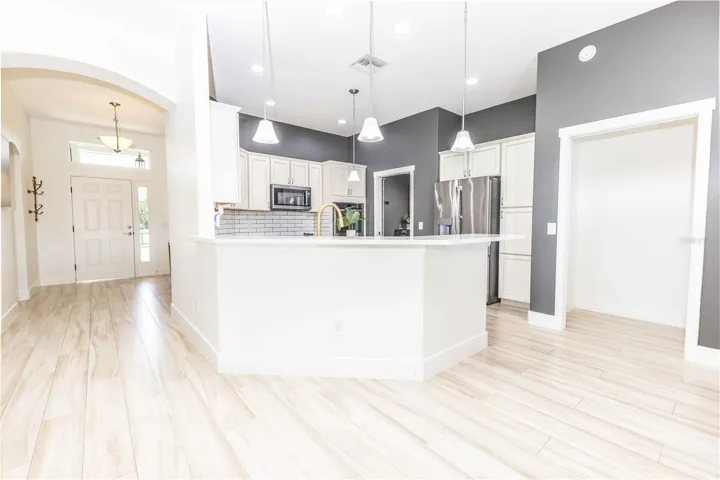 Kitchen opens to living and dining area