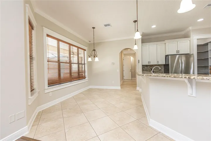 Dining space in kitchen overlooking pool