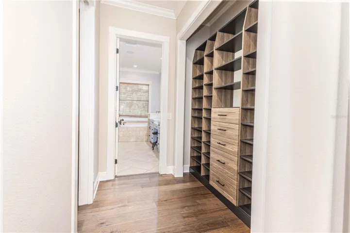 Walk-in closet of primary bedroom
