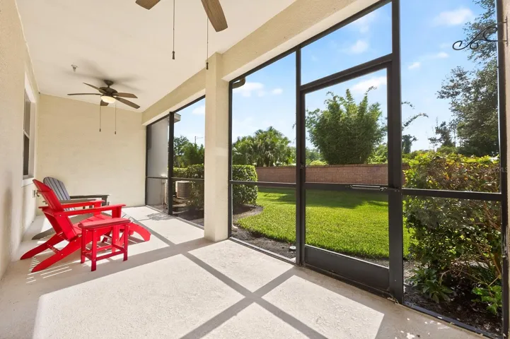A large screened lanai overlooks a landscaped green space.