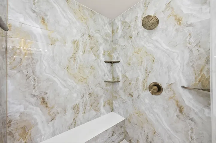 Primary en-suite bath custom tiled shower.