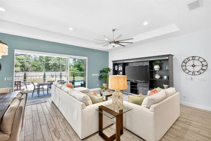 Living room with remote controlled blinds over sliding doors