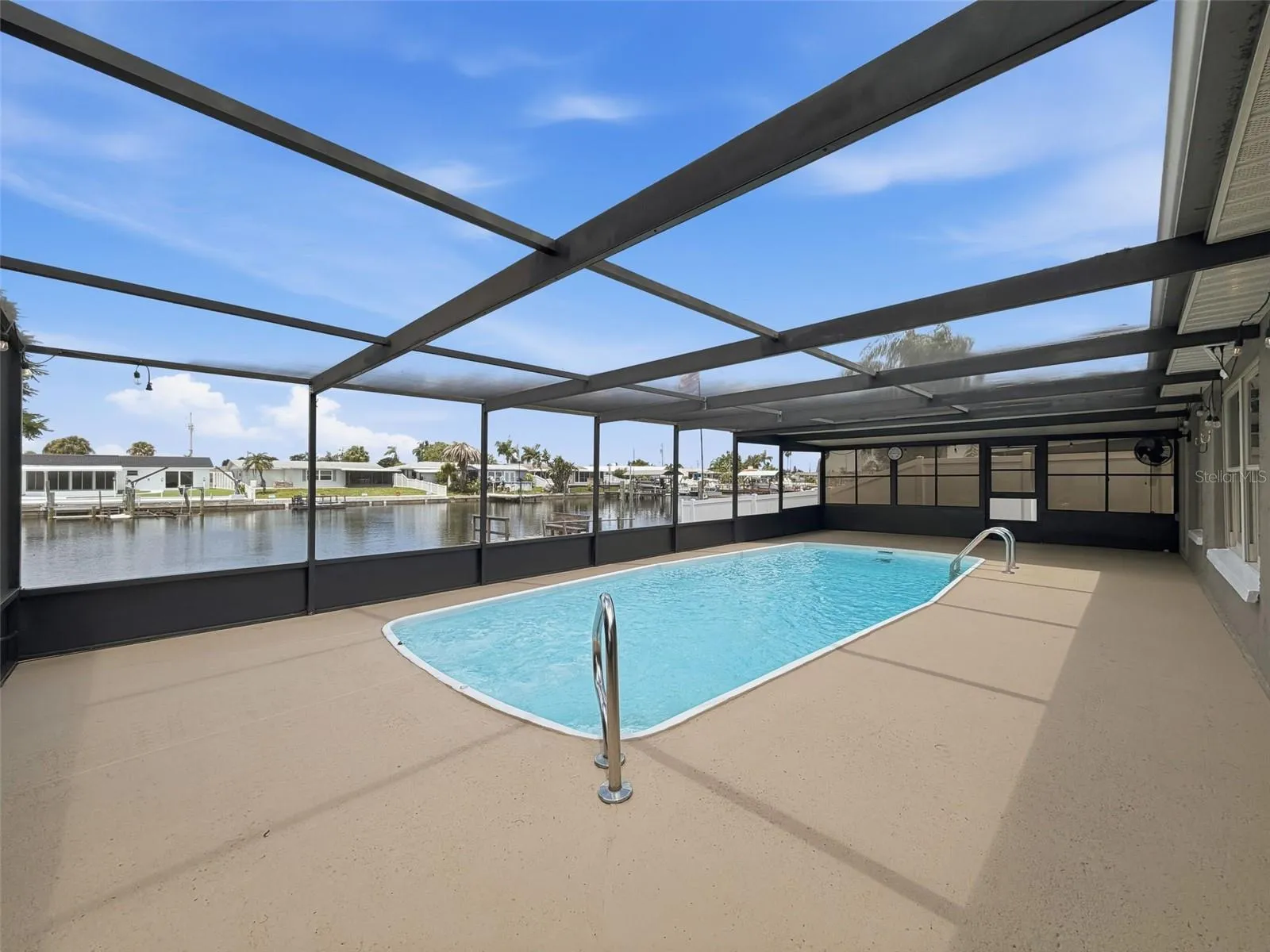 Relax poolside while enjoying peaceful canal views.