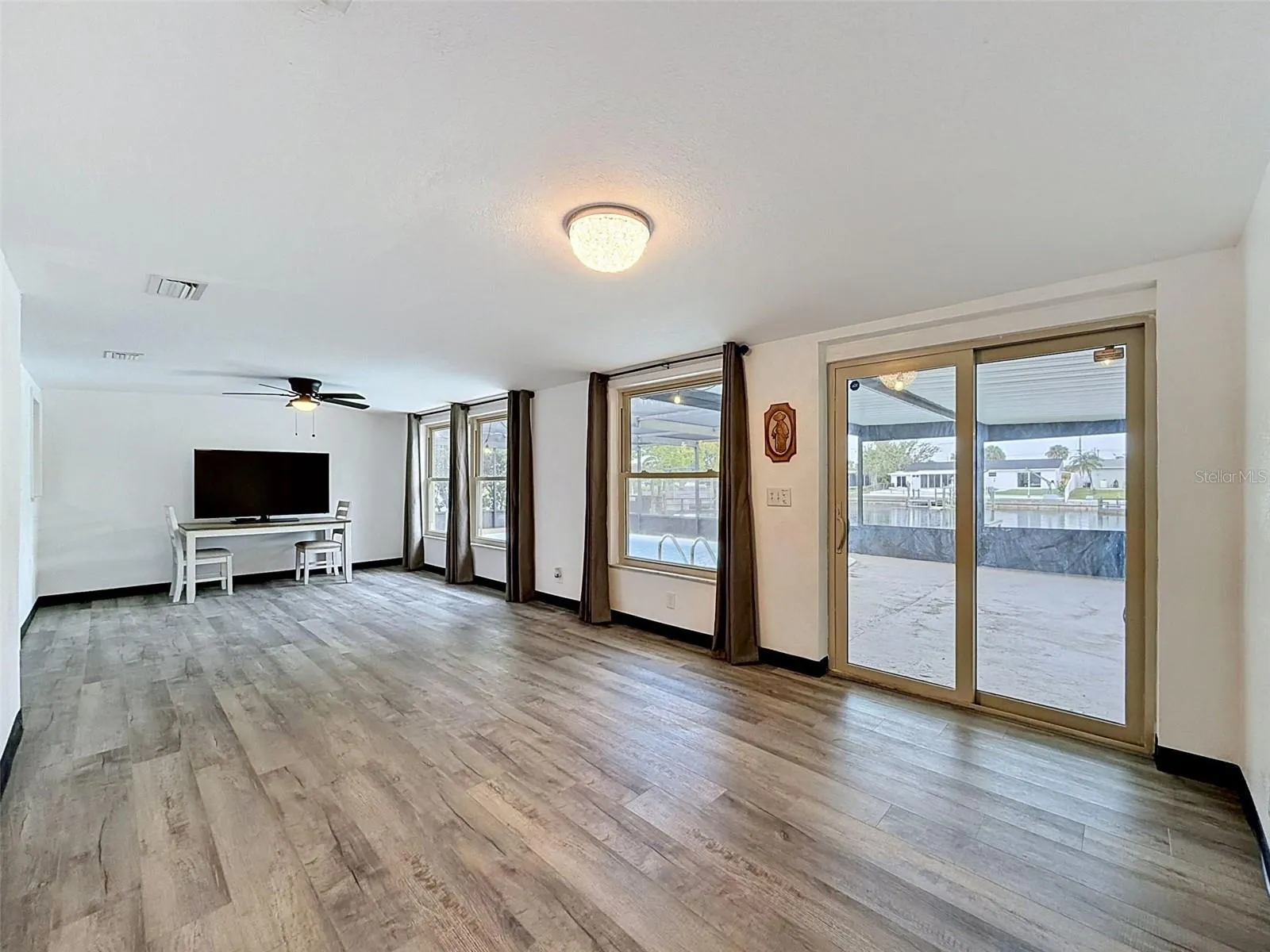 Spacious gathering room with direct pool access.