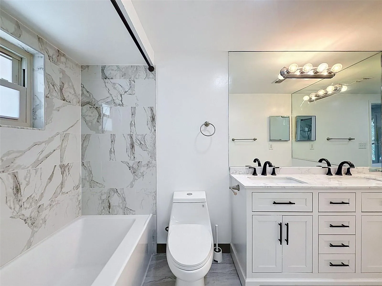 Thoughtfully updated bathroom with stylish coastal finishes.