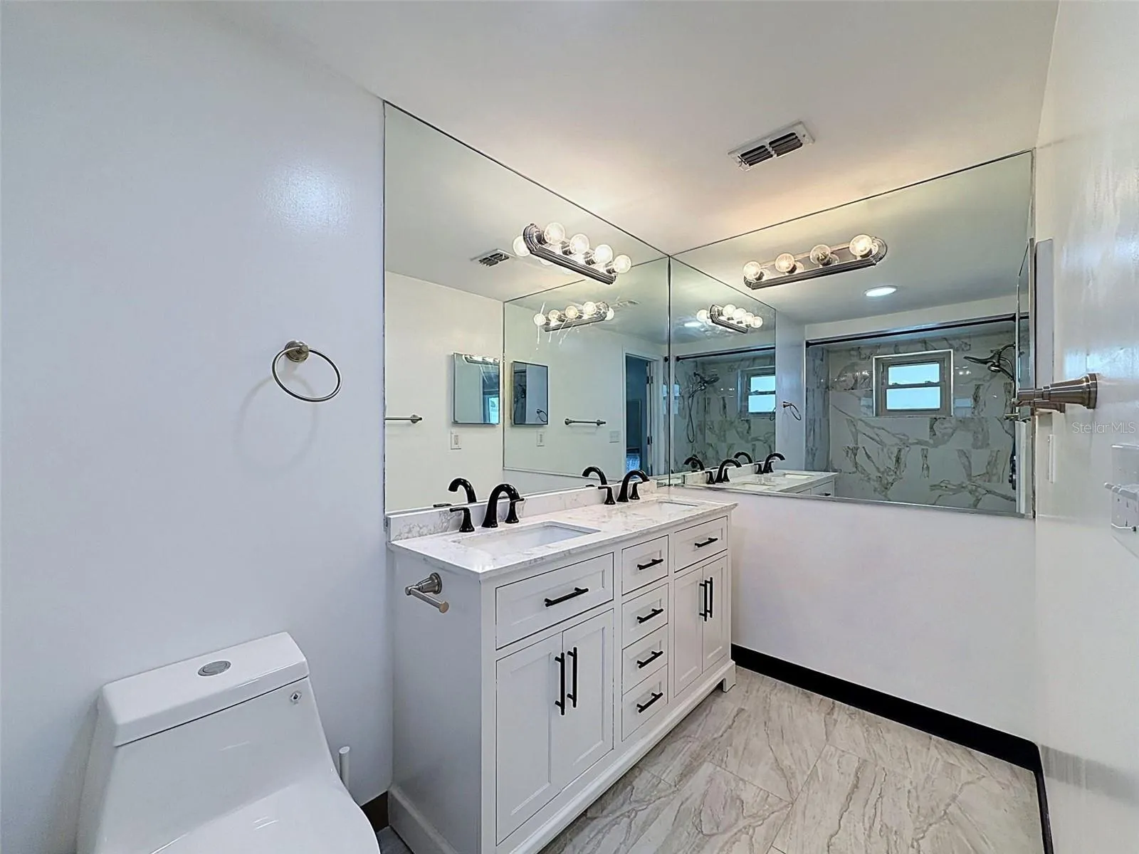 Large primary bath with generous storage and counter space.