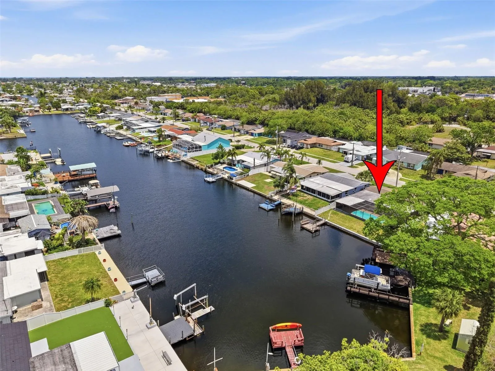 Aerial view highlights the home’s waterfront lot location.