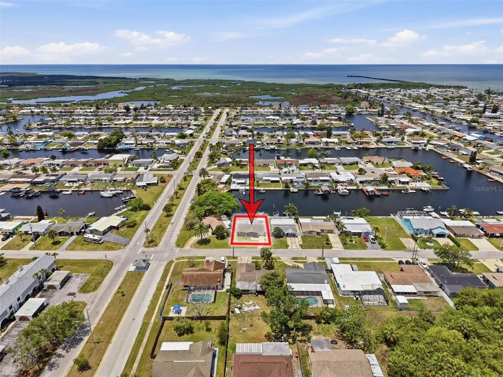 Aerial perspective highlights nearby canals and Gulf access.