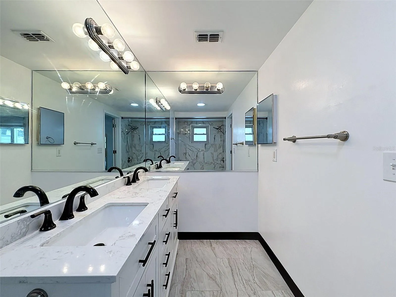 Spacious primary bathroom with double vanity.