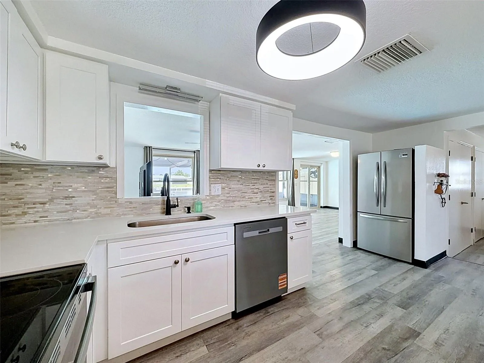 Beautiful white cabinetry brightens the kitchen space.