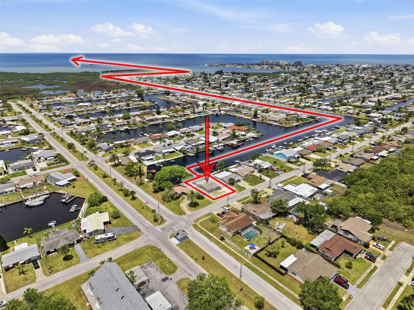Aerial view highlights the direct Gulf access route from the property.