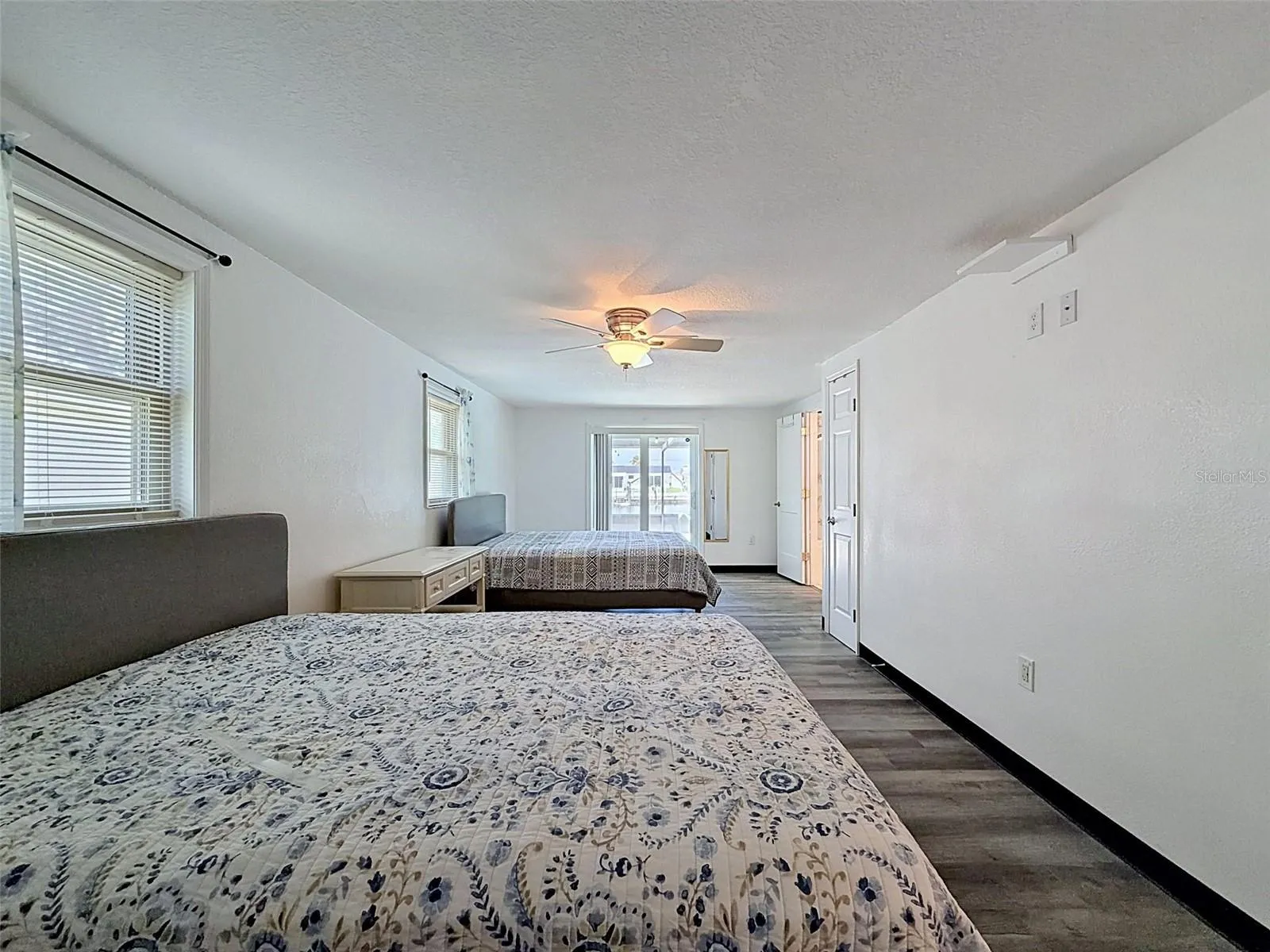 Sliding glass doors provide direct access to the pool area.