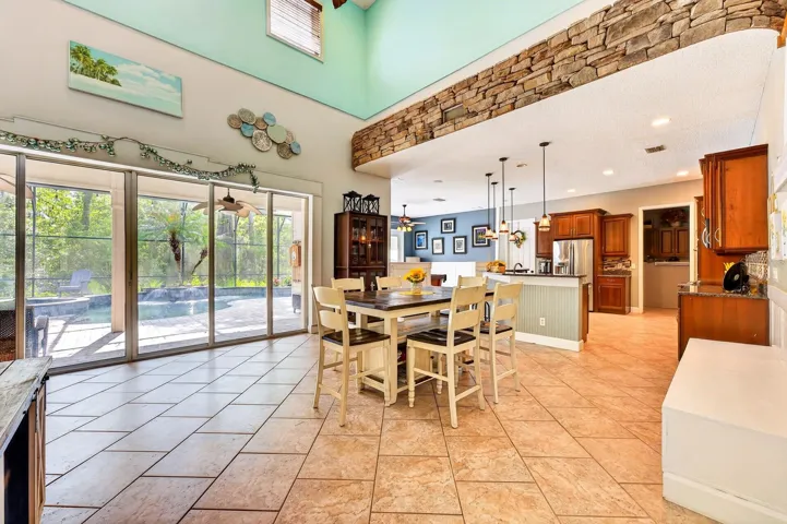 Light filled breakfast nook overlooks the pool throughout a wall of sliding glass doors.