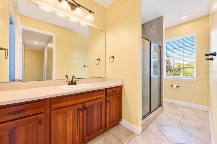 Third full bath has en-suite and hall access.