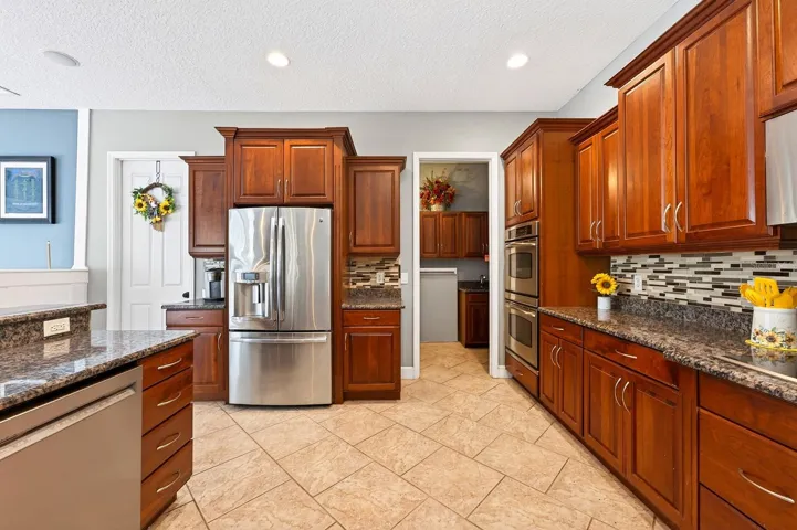 Rich solid wood cabinetry and stainless steel appliances.