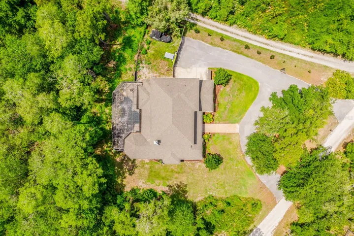 The home is surrounded by beautiful mature trees.