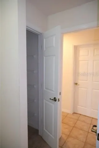 Laundry room has twin built-in linen closets