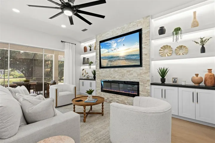 Fireplace & open floor plan to the pool/outdoor living area.