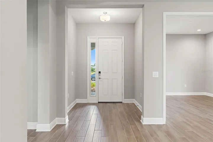 Welcoming foyer with high ceilings, clean architectural lines, and direct sightlines into the open living spaces.