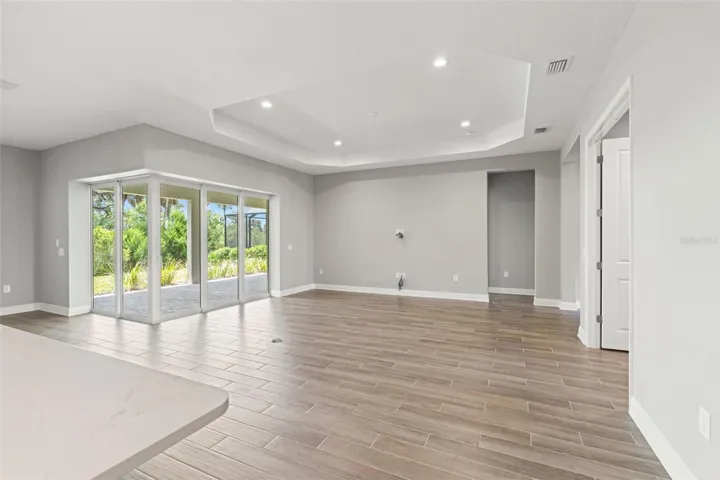 Open living space designed for entertaining, with seamless access to the covered outdoor area and tranquil natural surroundings.