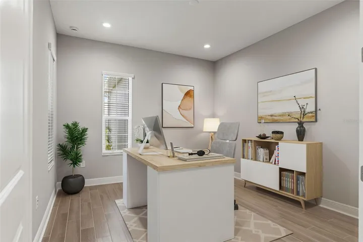 Dedicated office space with abundant natural light, wood-look tile flooring, and a clean, modern design ideal for working from home or creative pursuits.