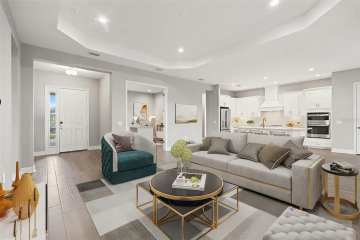 Open-concept living area seamlessly connects the great room and chef-inspired kitchen, complete with oversized island seating, recessed lighting, and elegant finishes throughout. Perfect for entertaining and everyday living.