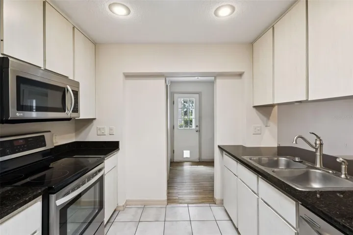 Kitchen with open views to the living room, granite counters and updated appliances