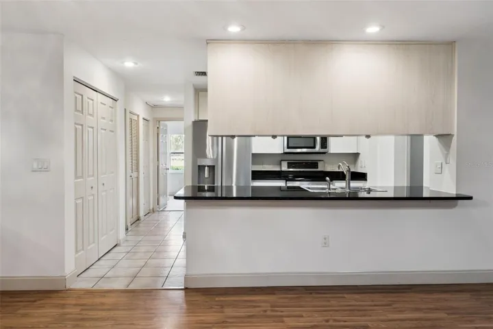 Kitchen with open views to the living room, granite counters and updated appliances