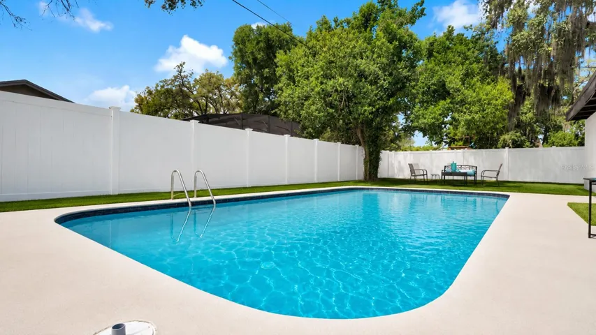 Expansive Backyard Pool Retreat with Privacy Fencing
