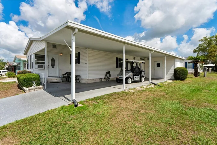 SIDE VIEW OF CARPORT, 2 CARS AND MORE SPACE NOT UNDER CARPORT.