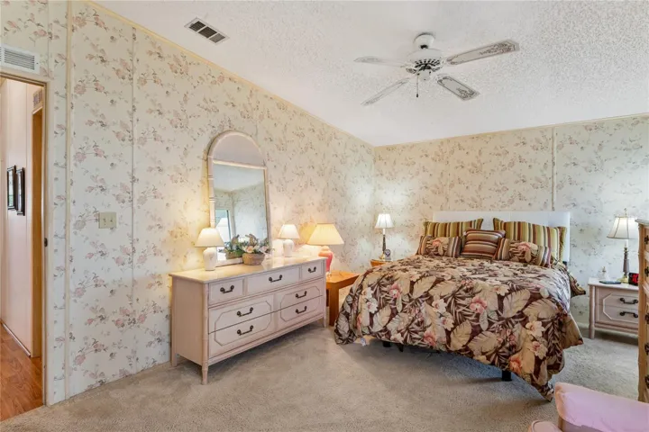 MASTER BEDROOM WITH DRESSER ANDCDILING FAN/LIGHT AND KING/QUEEN BED.