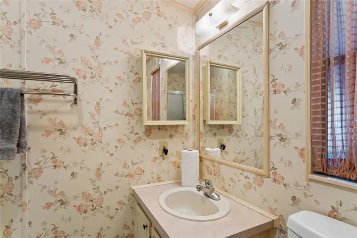 MASTER BATHROOM WITH UPDATED SHOWER AND TALL TOILET.  WALK-IN, TILE WALLS, BUILTIN SEAT