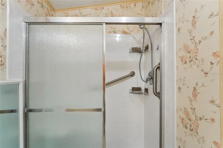 MASTER BATH, UPDATED WALK-IN BATH WITH TILE WALLS AND BUILT IN SEAT