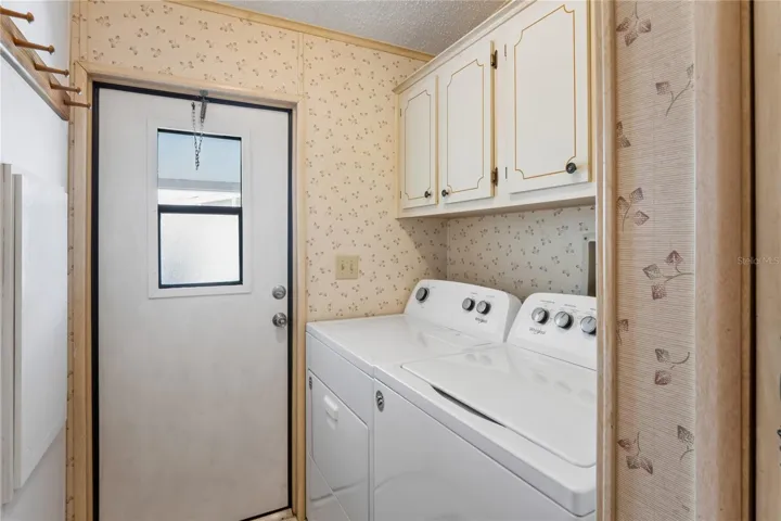 BACK DOOR IN LAUNDRY AREA AND TAKES YOU TO JUST A FEW STEPS TO THE CARPORT, BY THE SHED.