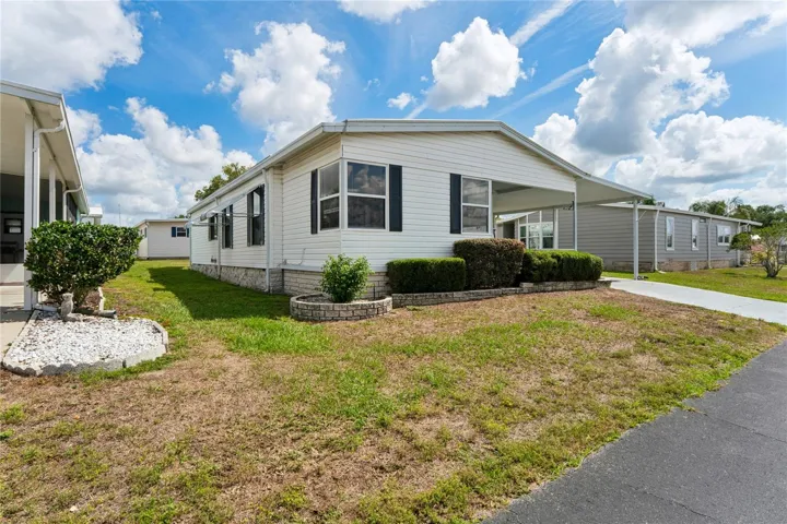 VIEW FROM THE STREET, SHUTTERS, VINYL SIDING, LONG DRIVEWAY