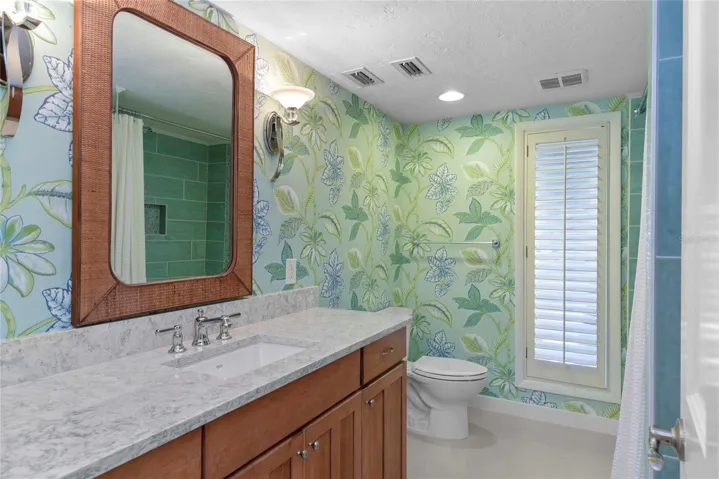 Bathroom #2 is en-suite to Bedroom #2 and also accessed from hallway for guests. Tub/Shower