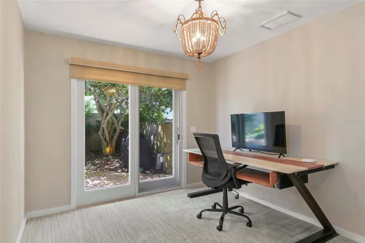 Private Office space adjacent to Kitchen and opens to the private, brick courtyard