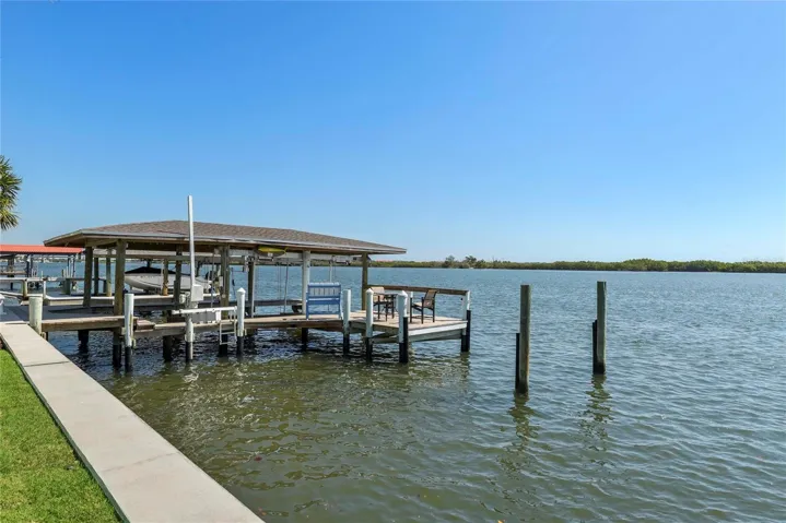 Seawall New in 2026. Private Dock w/ 20,000 covered boat lift, jet ski lift and 10x18 deck over the water