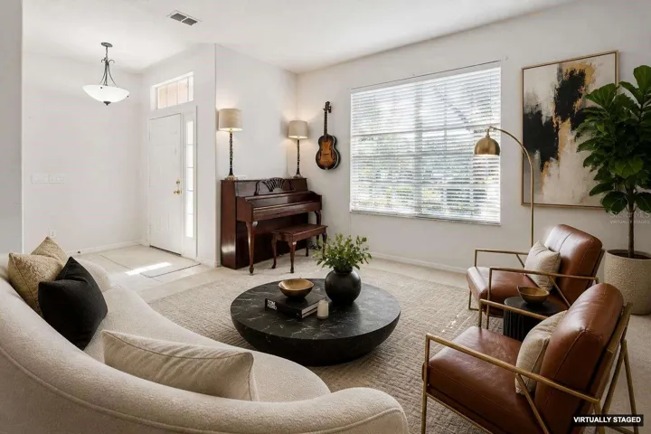 *Virtually staged* Bright entry way and a formal living room at the front of the home.