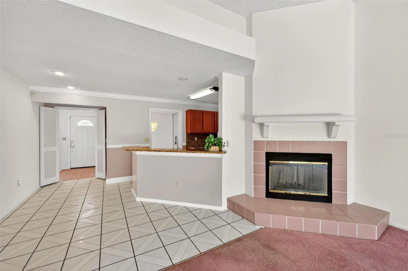 Family Room with Breakfast Bar to left of fireplace