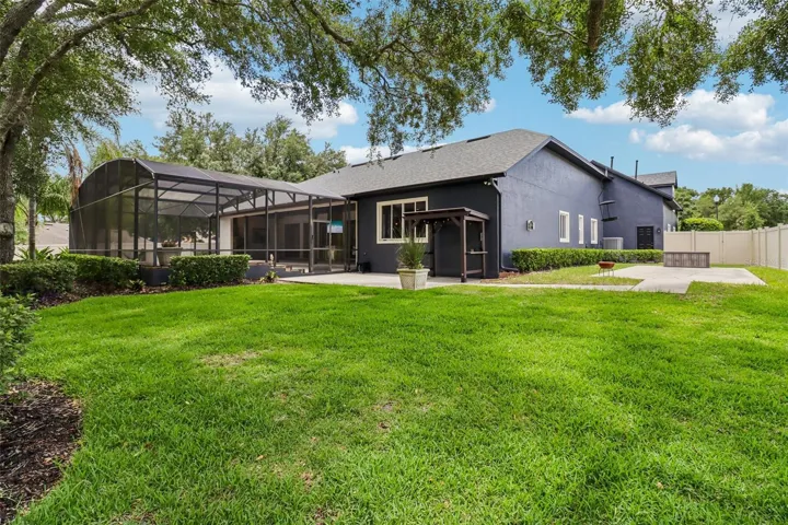 REAR VIEW W/ PORCH AND PERGOLA FOR GRILLING AND ADDED CONCRETE PAD 12X30