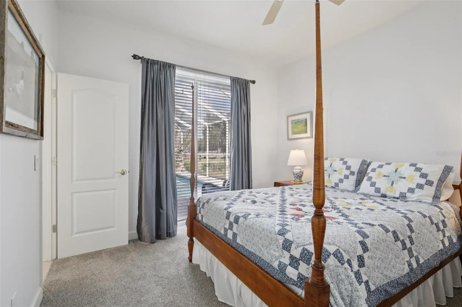 Second bedroom, with glass sliders to pool and cabana bathroom.