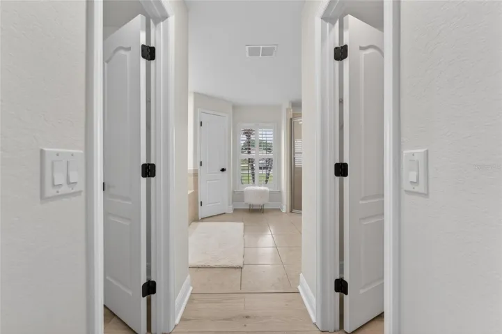 Entering into the beautiful primary bathroom suite